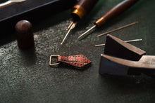 Load image into Gallery viewer, Zipper pull being pricked and ready to saddle stitch